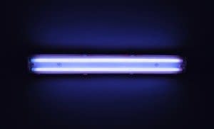 Detail shot of a fluorescent light tube on a wall with copyspace.